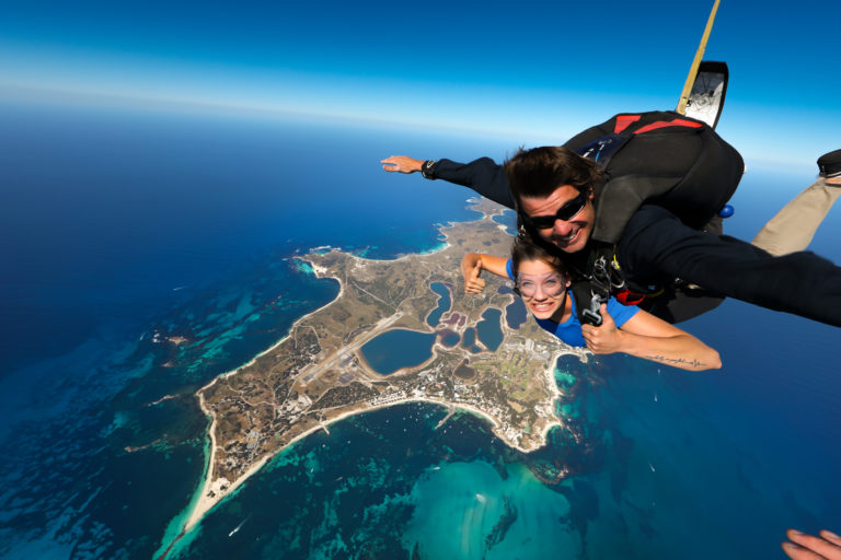 A man and a woman skydiving