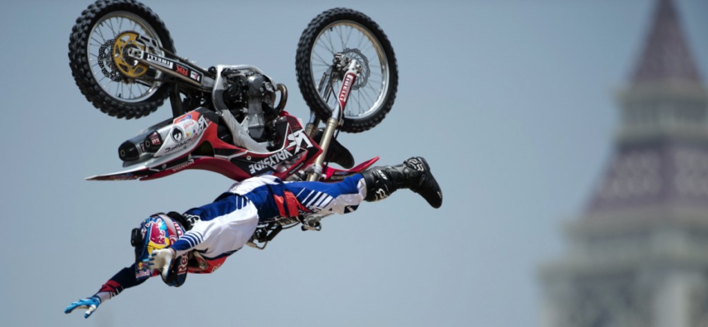 Man flying through the air on a motorcycle. 