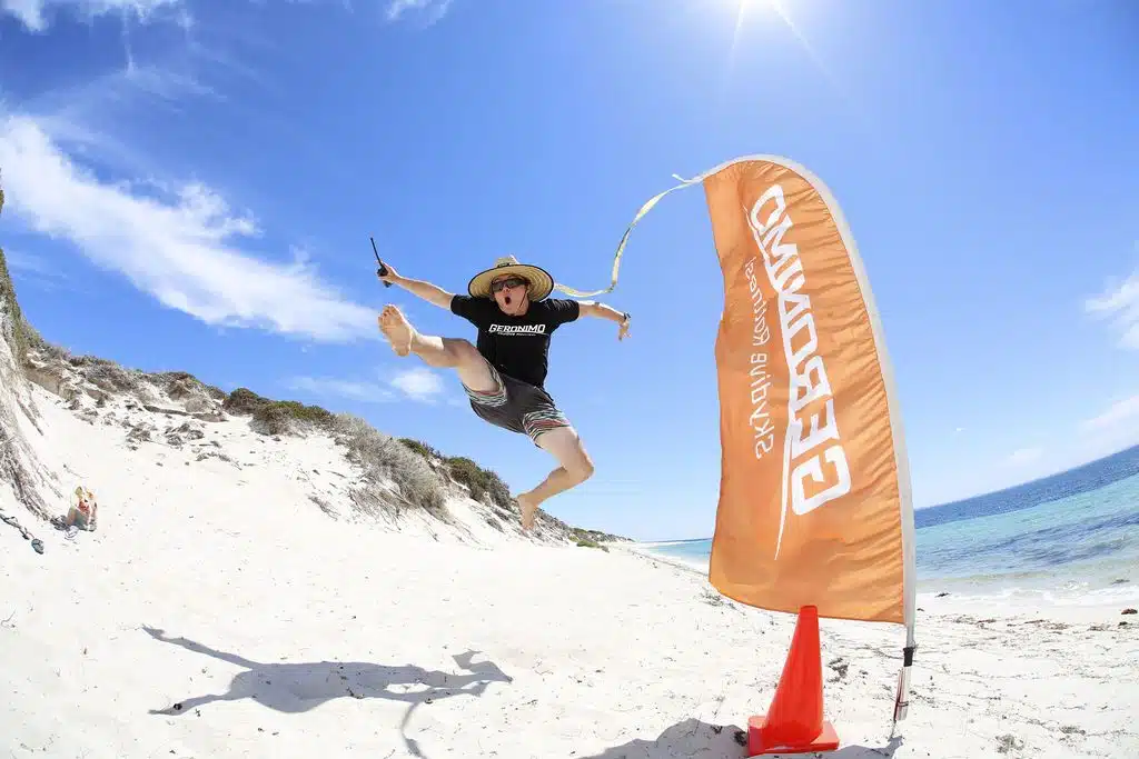 Jumping on the sand next to a flag for Geronimo